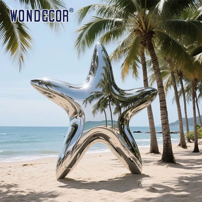 Large stainless steel star shaped outdoor sculpture in the park